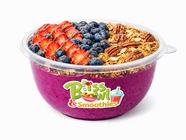 Purple smoothie bowl with strawberries, blueberries, granola